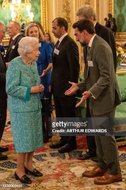 Britain's Queen Elizabeth II speaks to Saudi businessman H.E Yasir Othman Al-Rumayyan, , Governor of the Public Investment Fund , the sovereign...