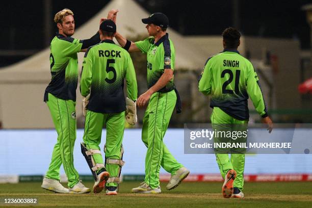 Ireland's Mark Adair celebrates with teammates after taking the wicket of Sri Lanka's Wanindu Hasaranga de Silva during the ICC men's Twenty20 World...