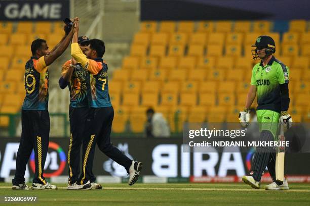 Sri Lanka's Chamika Karunaratne celebrates with teammates after taking the last wicket of Ireland during the ICC mens Twenty20 World Cup cricket...