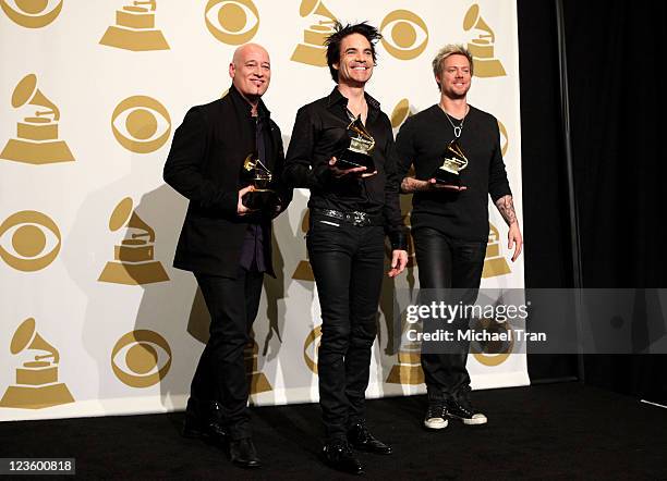 Jimmy Stafford, Pat Monahan, and Scott Underwood of the band Train pose in the press room at The 53rd Annual GRAMMY Awards held at Staples Center on...