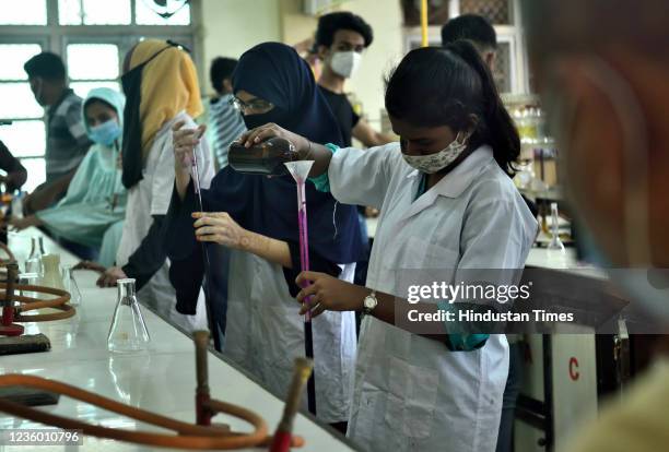 Students attend practicals in the laboratory at K.C. College on the first day after colleges reopen on October 20, 2021 in Mumbai, India. Mumbai...