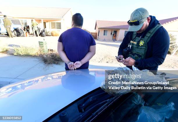 Resident of a home is detained and questioned by an Operation Hammer Strike deputy with the San Bernardino County Sheriffs Department after 316...