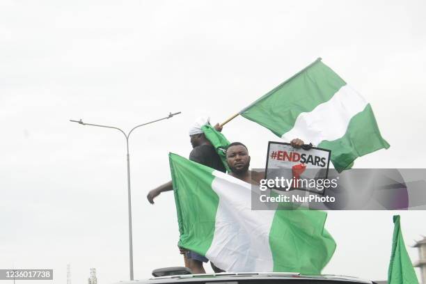 Protesters chant slogan songs during a protest to commemorate one year anniversary of #EndSars, a protest against a military attack on protesters at...
