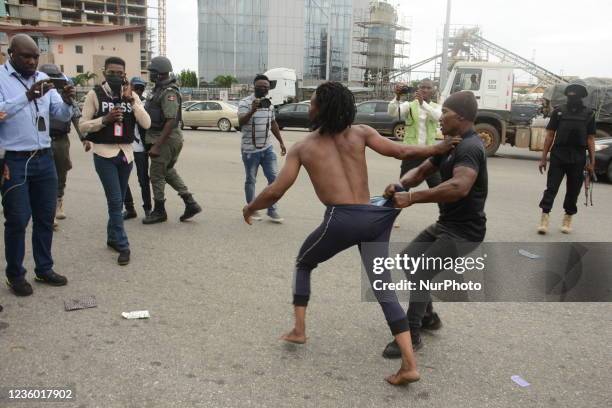 Policemen arrested a protester during a protest to commemorate one year anniversary of #EndSars, a protest against a military attack on protesters at...