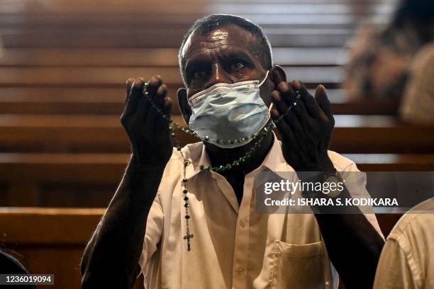 Man prays aduring a service at St. Anthonys church in Colombo on October 21 to mark 30 months since the coordinated 2019 Easter Sunday bombing at at...