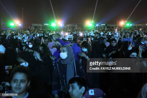 People attend the opening night of the Riyadh Season festivities in the Saudi capital late on October 20, 2021. - The arts and culture festival began...