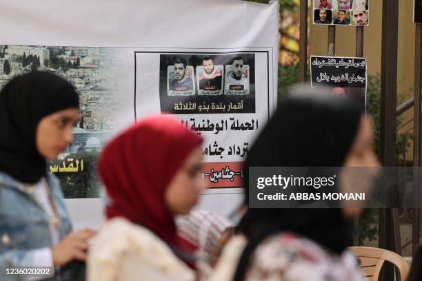 Palestinian women protest on October 21, 2021 in front of the offices of the Red Cross in Ramallah in the occupied West Bank to demand the release of...