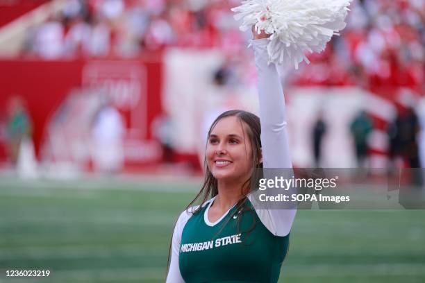Michigan State cheerleader cheers for the Spartans during an NCAA game against Indiana University at Memorial Stadium in Bloomington. .