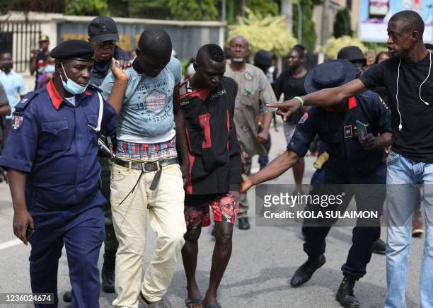 Officers of the Nigeria police force arrest people, during the trial of leader of the Proscribed Indigenous People of Biafra , Nnamdi Kanu, who is...