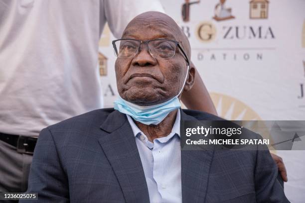 Former South African President Jacob Zuma addresses reporters outside the South African Police Service station in Pietermaritzburg on October 21,...