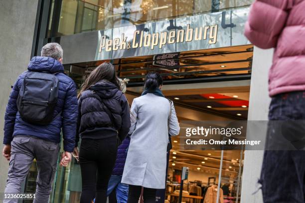 People walk past a Peek & Cloppenburg store on October 21, 2021 in Berlin, Germany. Retailers have voiced concern that the current disruption in...