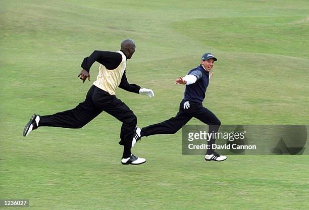Sergio Garcia of Spain leads basketball legend Michael Jordan of the USA in a sprint down the 16th fairway whilst playing in the Pro-Am of the Alfred...