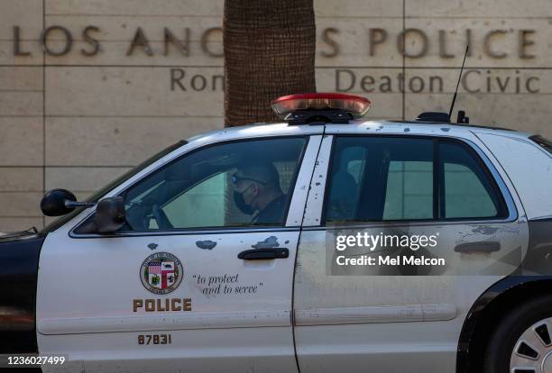 Member of the LAPD sits inside his squad car, parked outside their headquarters on 1st St. In downtown Los Angeles. Los Angeles will officially...