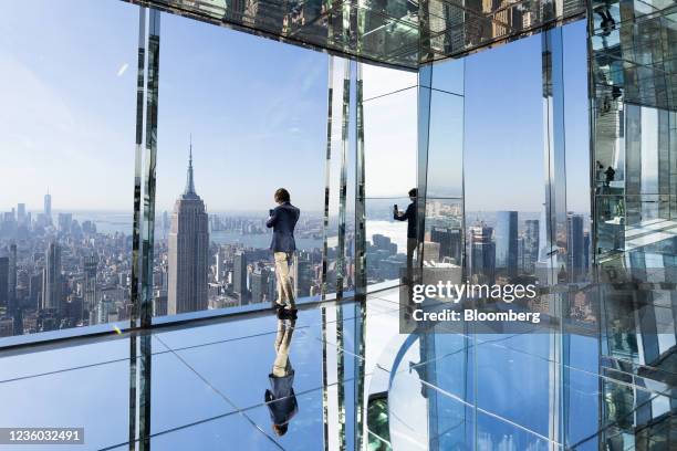 An attendee takes a selfie photograph during the grand opening of the Summit One Vanderbilt observation deck in New York, U.S., on Thursday, Oct. 21,...