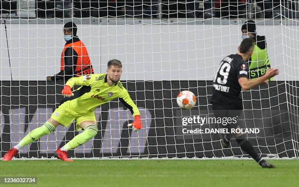 Frankfurt's Colombian forward Rafael Borre scores the opening goal from the penalty spot past Olympiakos' Czech goalkeeper Tomas Vaclik during the...