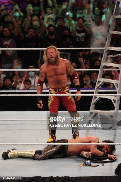 Edge stands over Seth Rollins after his win during the World Wrestling Entertainment Crown Jewel pay-per-view in the Saudi capital Riyadh on October...