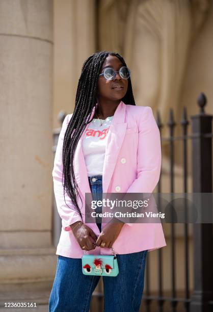 Lois Opoku is seen wearing pink blazer Zara, white tshirt Wangler, Levis denim jeans, sunglasses Fendi, mini bag Fendi on May 30, 2020 in Berlin,...