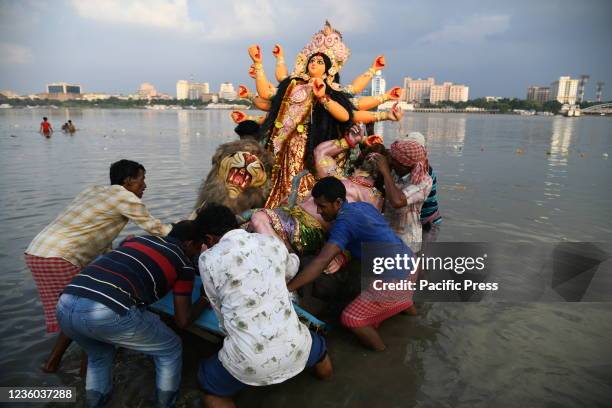 Durga idol immersion ceremony after the end of Durga Puja at the riverbank of the Ganges amid 2nd year of Covid-19 pandemic. The worship of Goddess...