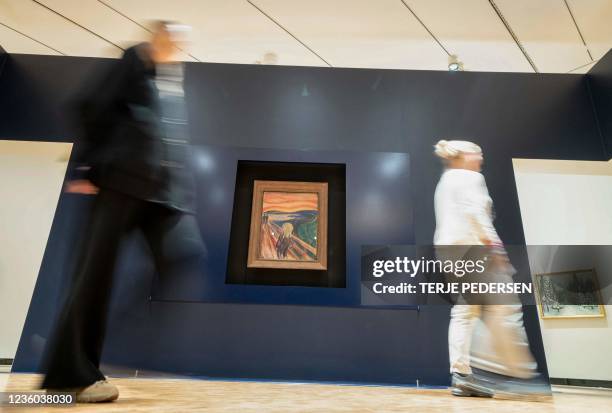 People pass by the painting "The Scream" by Norwegian artist Edvard Munch in the new Munch museum in Oslo on September 7, 2021. - On October 22 the...
