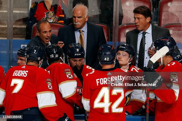 Florida Panthers Assistant Coach Derek MacKenzie directs his team along with Head Coach Joel Quenneville and fellow Assistant Coach Ulf Samuelsson...