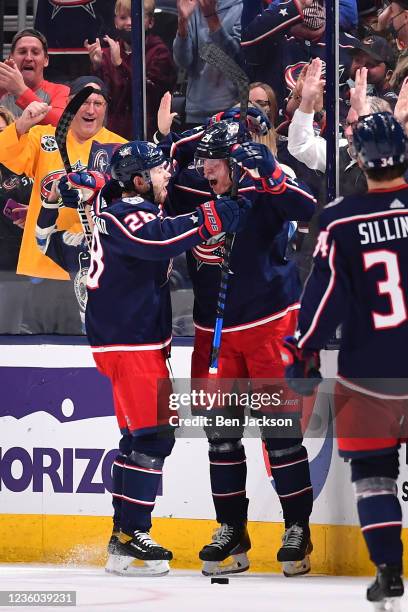 Patrik Laine of the Columbus Blue Jackets celebrates his game-winning overtime goal with teammate Oliver Bjorkstrand of the Columbus Blue Jackets...