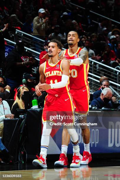 John Collins and Trae Young of the Atlanta Hawks share a moment during the game against the Dallas Mavericks on October 21, 2021 at State Farm Arena...