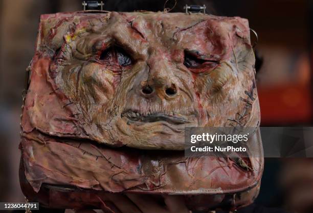 An activist from the organisation Animal Save Movement Mexico, holds a bag with artificial blood while demonstrating outside the luxury shop Hermès,...