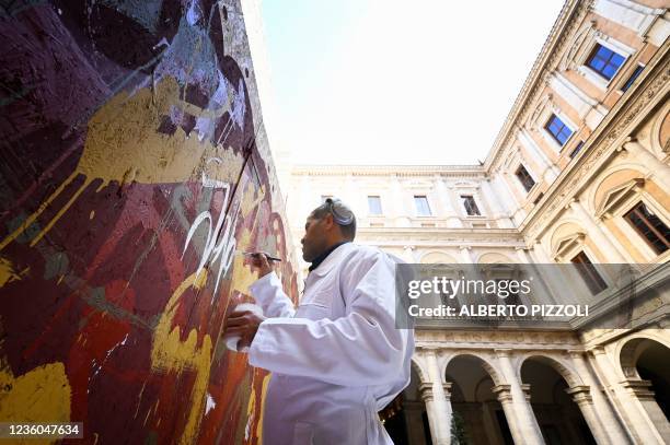 Street artist Artist JonOne, known for a abstract expressionist-styled graffiti, works on his piece "Cippo 2.0" on October 20, 2021 at Palazzo...