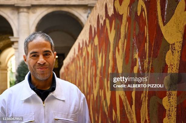 Street artist Artist JonOne, known for a abstract expressionist-styled graffiti, poses by his piece "Cippo 2.0" on October 20, 2021 at Palazzo...