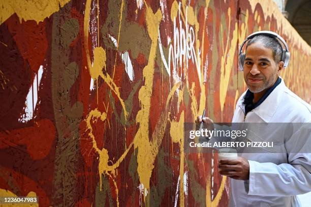 Street artist Artist JonOne, known for a abstract expressionist-styled graffiti, works on his piece "Cippo 2.0" on October 20, 2021 at Palazzo...
