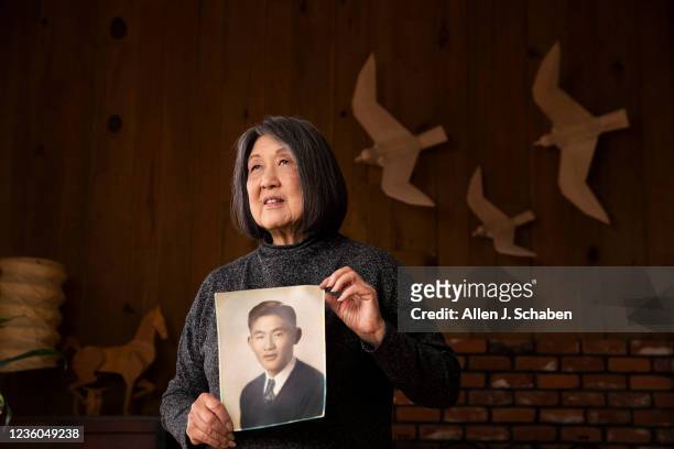 Joanne Kumamoto's father, Jiro Oishi, shown in photo, was one of the 120 Nisei students deprived of a degree as she is photographed with birds and a...