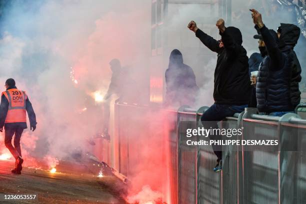 Saint-Etienne supporters launch smoke canisters to protest against the last place of their football club in the ranking of the French L1...