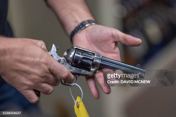 Props expert Guillaume Delouche at Independent Studio Services holds a prop gun while talking about them in Sunland-Tujunga, Los Angeles, California...