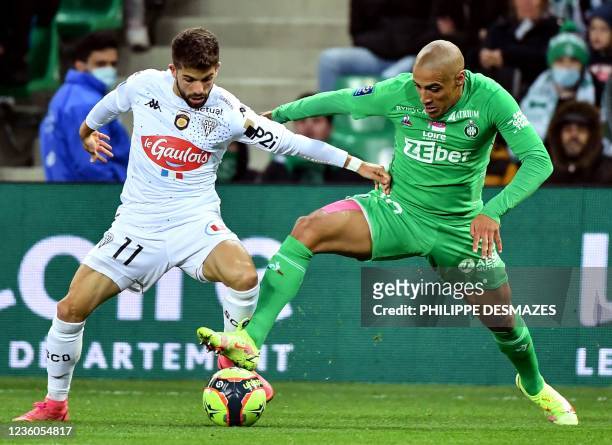 Angers' French midfielder Jimmy Cabot challenges Saint-Etienne's Uruguayan forward Wahbi Kahbi , during the French L1 football match between AS...