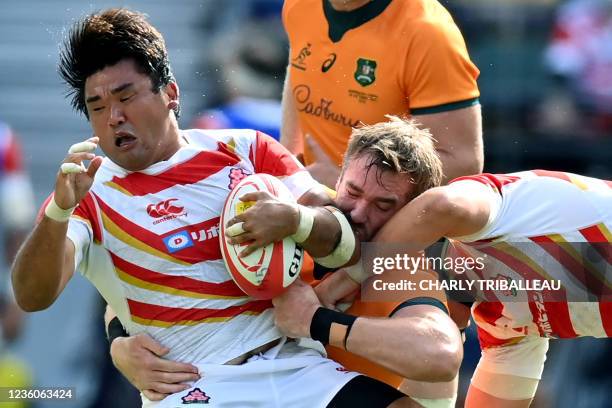 Japan's Gu Jiwon is tackled during the international friendly rugby union test match between Japan and Australia at the Oita Stadium in Oita on...