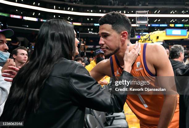 Kendall Jenner and Devin Booker of the Phoenix Suns kiss and hug after the Suns defeated the Los Angeles Lakers, 115-110, at Staples Center on...