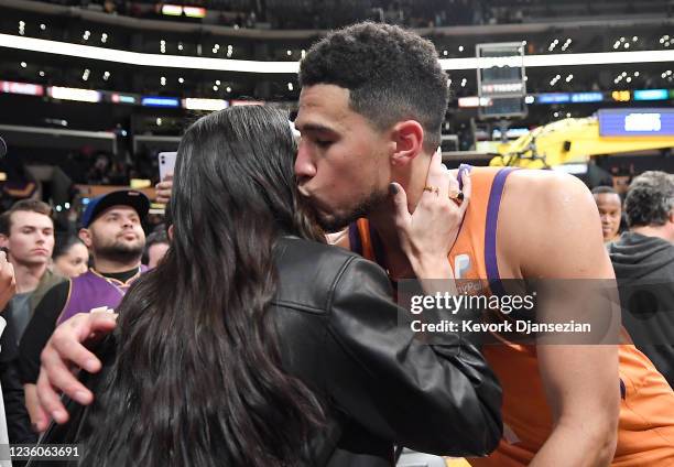 Kendall Jenner and Devin Booker of the Phoenix Suns kiss and hug after the Suns defeated the Los Angeles Lakers, 115-110, at Staples Center on...