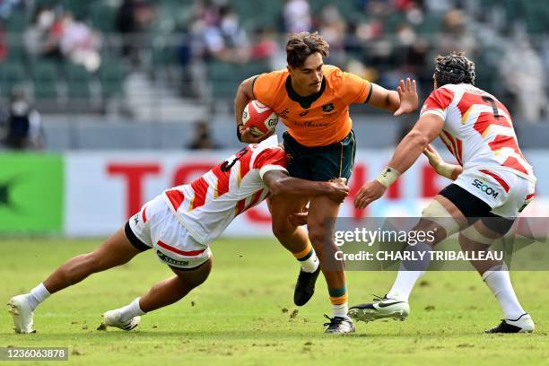 Australia's Jordan Petaia is tackled by Japan's Gu Jiwon during the international friendly rugby union test match between Japan and Australia at the...