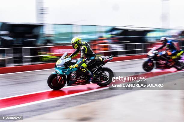 Yamaha-SRT Italian rider Valentino Rossi departs on October 23, 2021 for a free practice session on the eve of the Emilia-Romagna MotoGP Grand Prix...