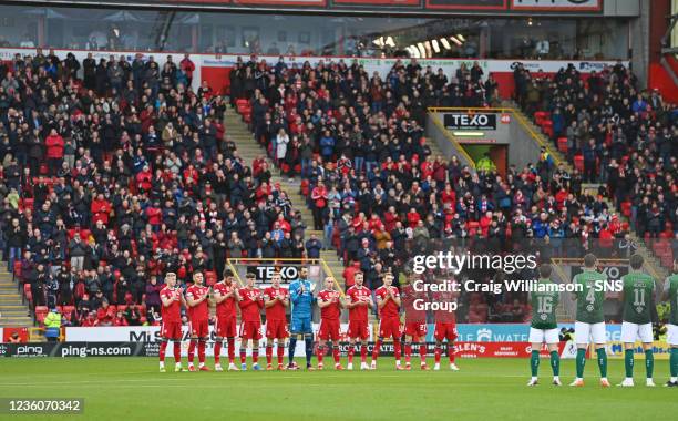 Before kick-off, players, match officials and supporters observe a minute's applause in memory of Aberdeen's former captain, George Kinnell during...