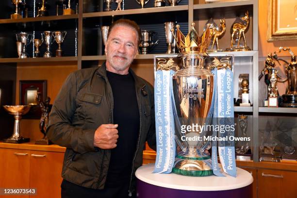 Arnold Schwarzenegger poses with the Premier League Trophy in Santa Monica, ahead of the Premier League Mornings Live fan festival taking place at...