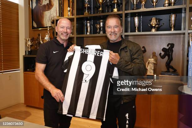 English Premier League record goalscorer Alan Shearer pictured with Liverpool FC fan Arnold Schwarzenegger holding a Newcastle United F.C. Shirt with...