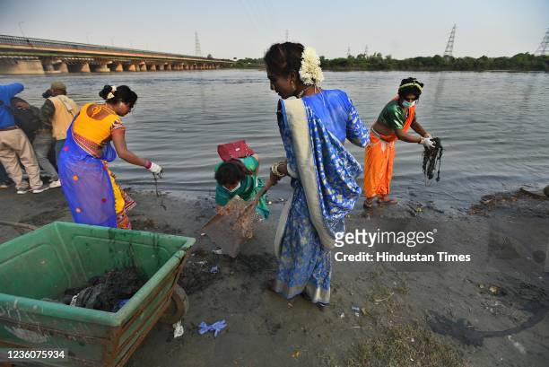 Members of the transgender participate in a cleanliness drive on the banks of Yamuna river, near ITO, on October 23, 2021 in New Delhi, India.