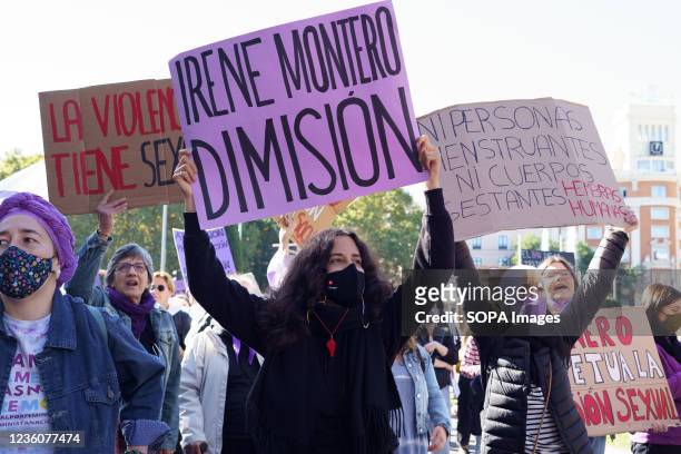 Protesters hold placards during the demonstration. Demonstrators marched on the streets of the capital from Neptune fountain to the Puerta del Sol,...