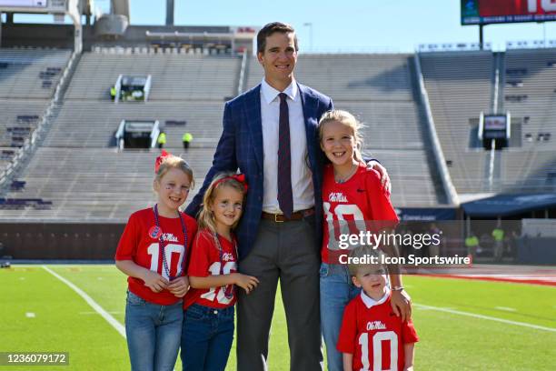 Former Ole' Miss and New York Giants quarterback, Eli Manning, poses with family members before the college football game between the LSU Tigers and...