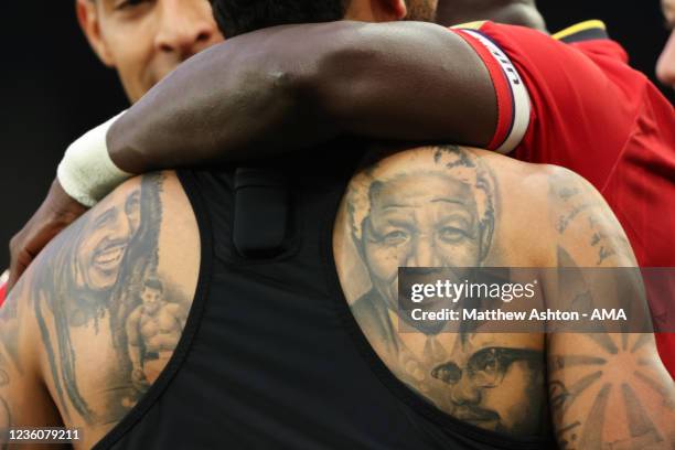 After scoring a hat-trick, Joshua King of Watford celebrates after scoring a goal to make it 2-4 showing off his black history tattoos including Bob...