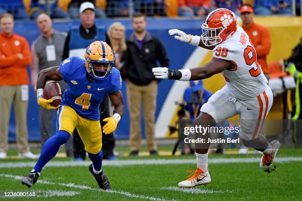 Melquise Stovall of the Pittsburgh Panthers looks to evade a tackle attempt by Myles Murphy of the Clemson Tigers in the first quarter during the...