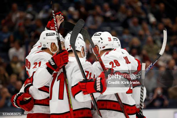 Jesper Fast of the Carolina Hurricanes is congratulated by his teammates after scoring a goal during the first period of the game against the...