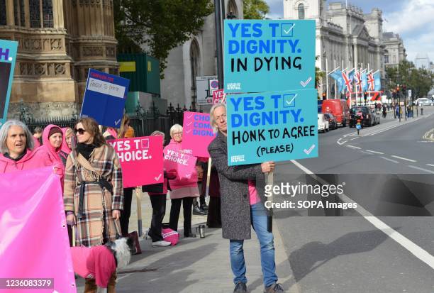 Man holds a placard expressing his opinion at Abingdon Street during the demonstration. Protesters support legal assisted dying for terminally ill...