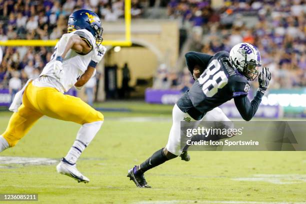 Horned Frogs wide receiver Quincy Brown catches a pass for a first down as West Virginia Mountaineers cornerback Jackie Matthews chases him during...